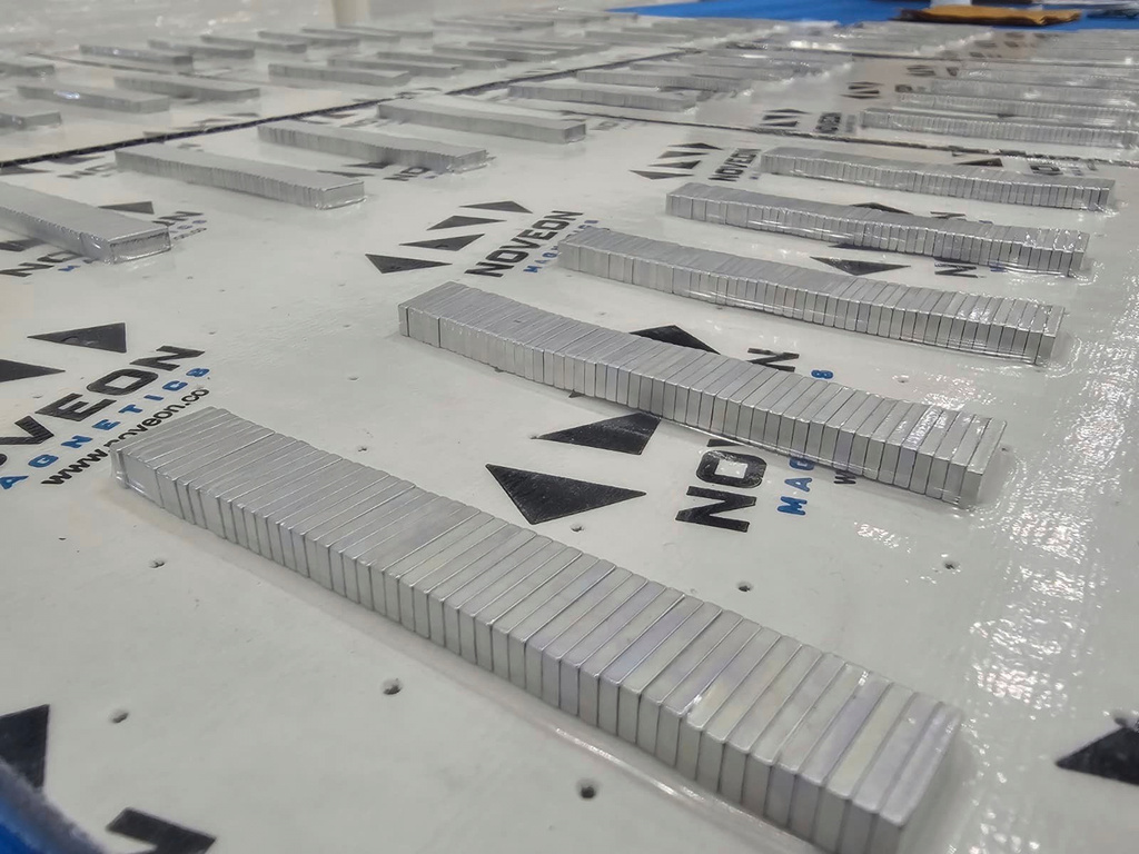 This photo provided by Noveon Magnetics, stacks of finished rare earth magnets sit inside the Noveon Magnetics factory in San Marcos, Texas, ready to be delivered to customers who will use them in various high-tech products. (Noveon Magnetics via AP)