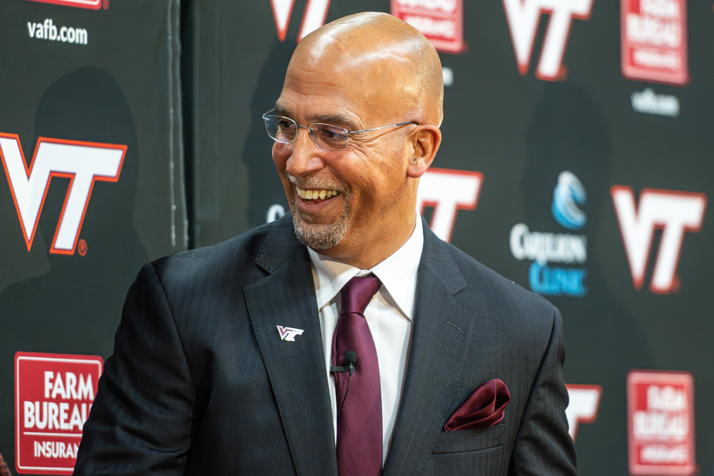 James Franklin, Virginia Tech's new head football coach, smiles after he was presented with a team jersey during an NCAA college football news conference, Wednesday, Nov. 19, 2025, in Blacksburg, Va. (AP Photo/Robert Simmons)