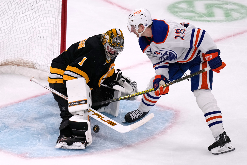 Boston Bruins goaltender Jeremy Swayman (1) makes a save on a shot by Edmonton Oilers left wing Zach Hyman (18) during the third period of an NHL hockey game, Thursday, Dec. 18, 2025, in Boston. (AP Photo/Charles Krupa)