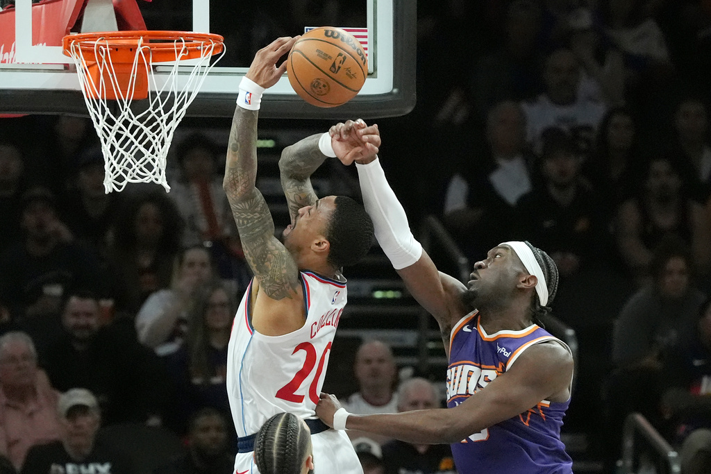 Phoenix Suns center Mark Williams, right, blocks a shot by Los Angeles Clippers forward John Collins, left, during the first half of an NBA basketball game Sunday, Feb. 1, 2026, in Phoenix. (AP Photo/Ross D. Franklin)
