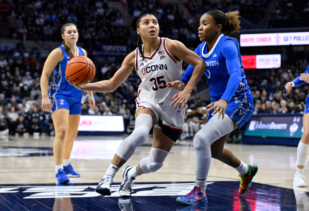 UConn guard Azzi Fudd (35) drives to the basket as Creighton guard Kendall McGee defends in the first half of an NCAA college basketball game, Wednesday, Feb. 11, 2026, in Storrs, Conn. (AP Photo/Jessica Hill)