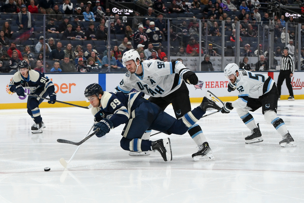 Utah Mammoth defenseman Mikhail Sergachev (98) defends Columbus Blue Jackets left wing Matthew Knies (89) during the third period of an NHL hockey game, Saturday, Oct. 3, 2026, in Columbus, Ohio. (AP Photo/Tanner Pearson)