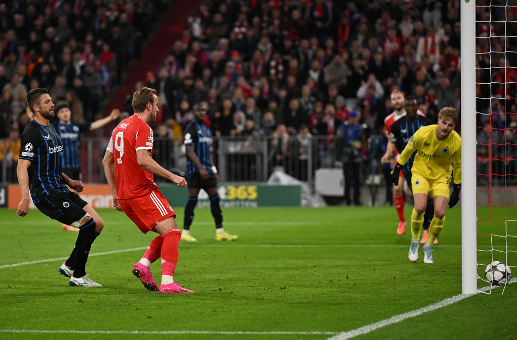 Bayern Munich's Harry Kane, center, scores during the Champions League soccer match between Bayern Munich and FC Brugge in Munich, Germany, Wednesday Oct. 22, 2025. (Sven Hoppe/dpa via AP)