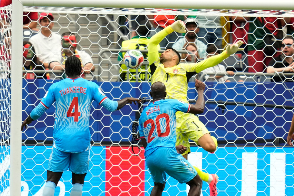 Congo's Yoane Wissa (20) scores his side's first goal against Portugal goalkeeper Diogo Costa during the World Cup Group K soccer match between Portugal and Congo in Houston, Wednesday, June 17, 2026. (AP Photo/Karen Warren)