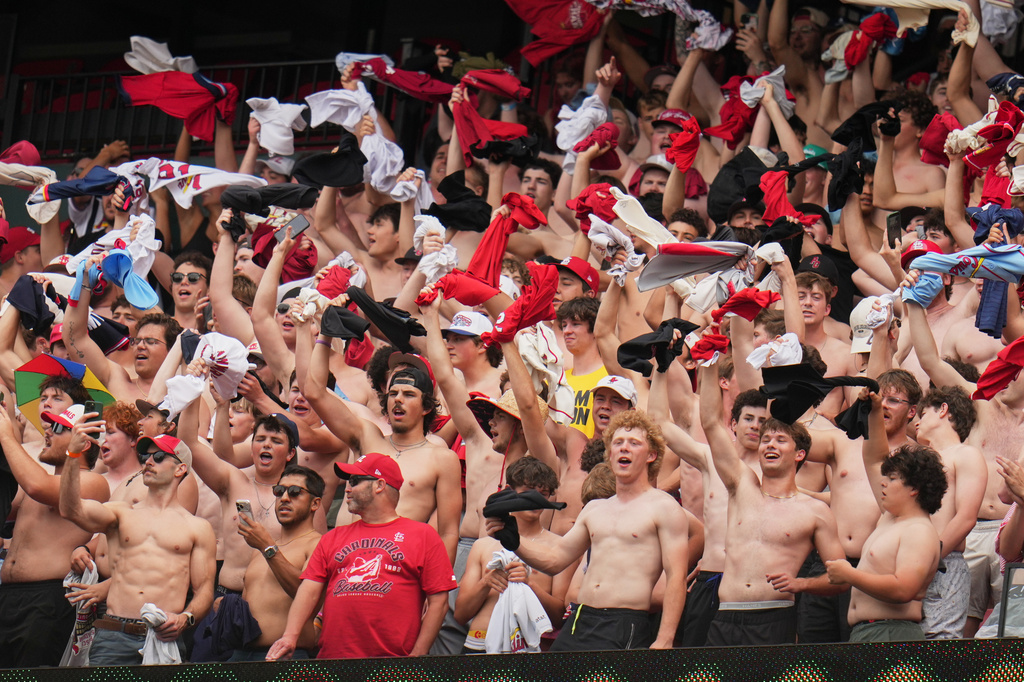 Fans cheer and wave their shirts above their heads during the fifth inning of a baseball game between the St. Louis Cardinals and the Kansas City Royals Saturday, May 16, 2026, in St. Louis. (AP Photo/Jeff Roberson)