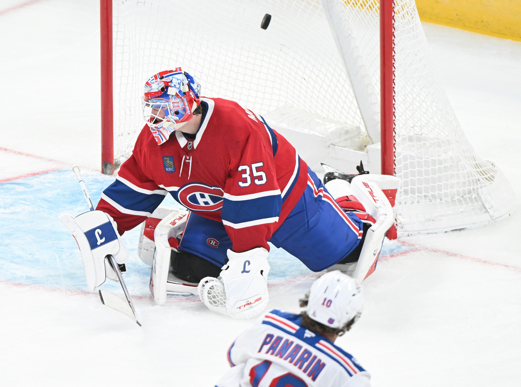 New York Rangers' Artemi Panarin (10) scores against Montreal Canadiens goaltender Sam Montembeault during the third period of an NHL hockey game in Montreal, Saturday, Oct. 18, 2025. (Graham Hughes/The Canadian Press via AP)