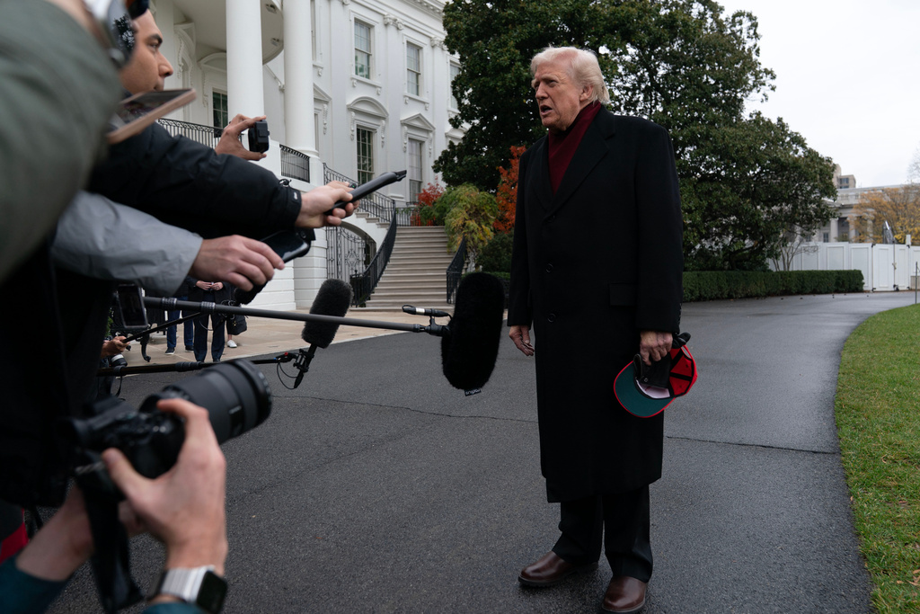 President Donald Trump talks to reporters as he departs from the South Lawn of the White House, Saturday, Nov. 22, 2025, in Washington, en route to Joint Base Andrews. (AP Photo/Jose Luis Magana)