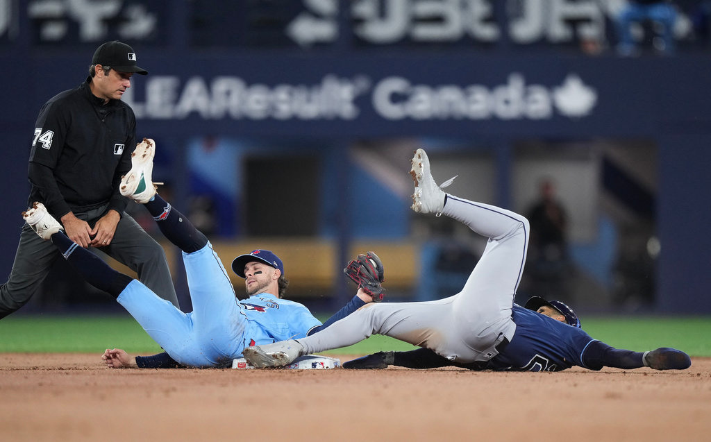 Toronto Blue Jays second baseman Ernie Clement (22) tags out Tampa Bay Rays' Victor Mesa Jr. (25) trying to steal second base during ninth inning of a baseball game in Toronto on Wednesday, July 22, 2026. (Nathan Denette/The Canadian Press via AP)