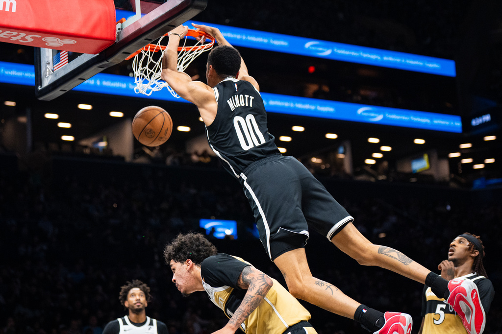 Brooklyn Nets forward Josh Minott (00) dunks during the first half of an NBA basketball game against the Washington Wizards, Sunday, April 5, 2026, in New York. (AP Photo/Angelina Katsanis)