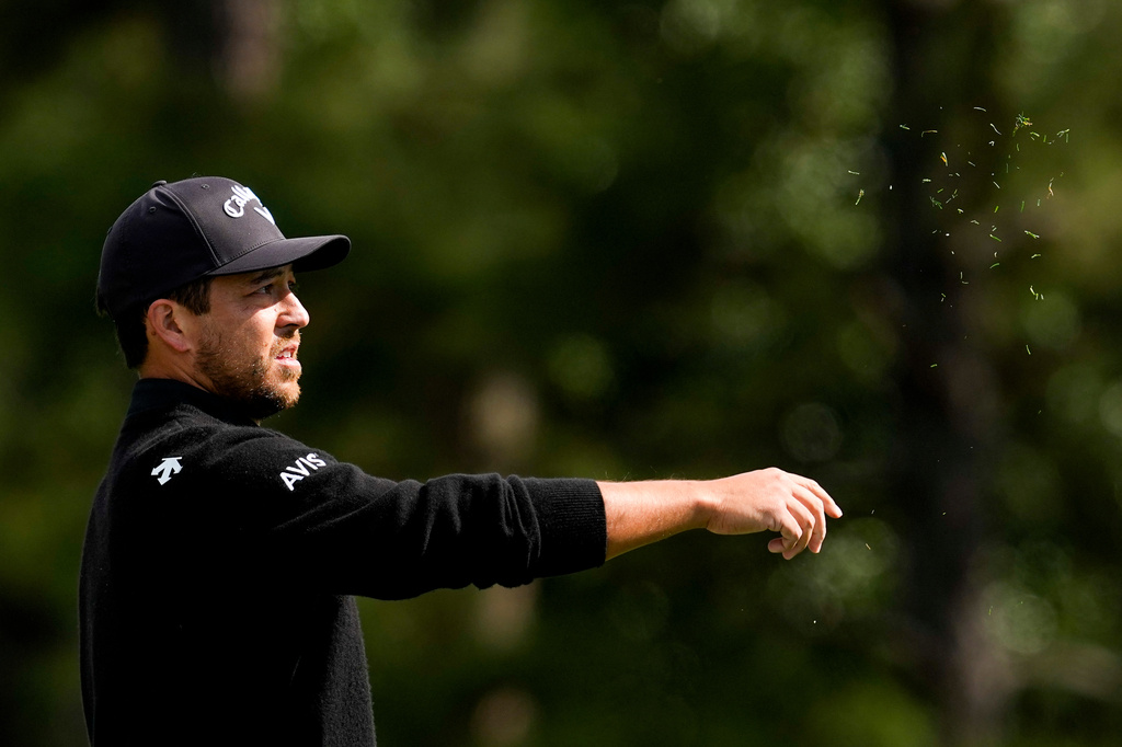 Xander Schauffele checks the wind on the first hole during the first round of the Masters golf tournament at the Augusta National Golf Club, Thursday, April 9, 2026, in Augusta, Ga. (AP Photo/Ashley Landis)