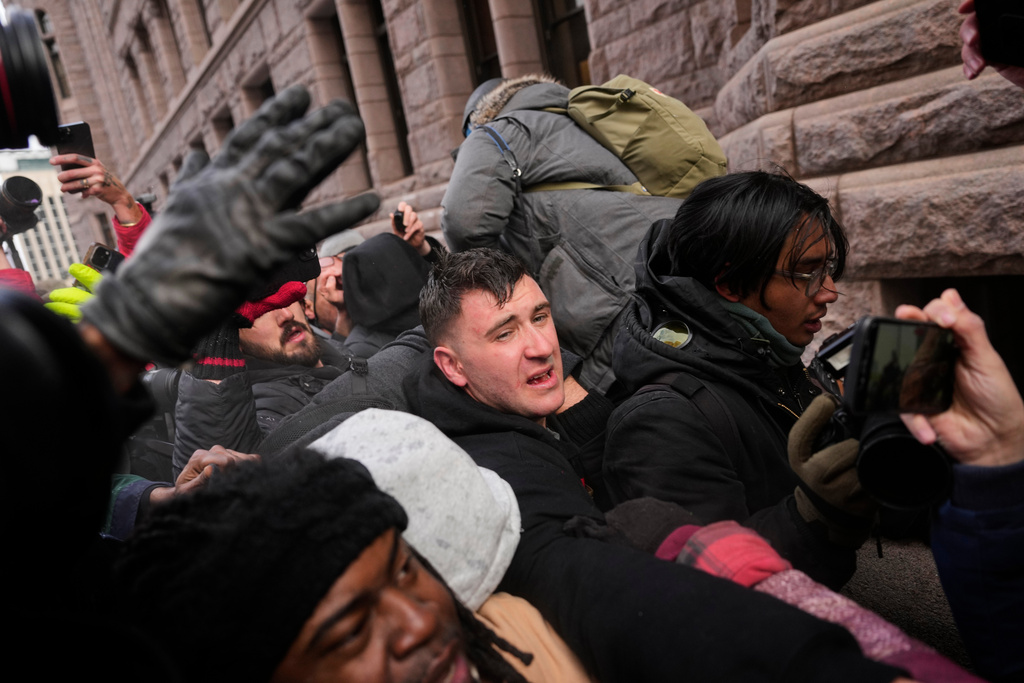Jake Lang, center, who organized the protest March Against Minnesota Fraud, clashes with pro-immigration counterprotesters near Minneapolis City Hall, Saturday, Jan. 17, 2026, in Minneapolis. (AP Photo/Yuki Iwamura)