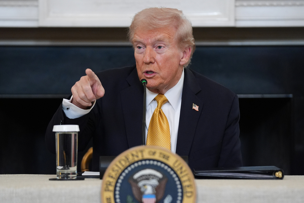 President Donald Trump points to a reporter to ask a question during a roundtable on criminal cartels in the State Dining Room of the White House, Thursday, Oct. 23, 2025, in Washington. (AP Photo/Evan Vucci)
