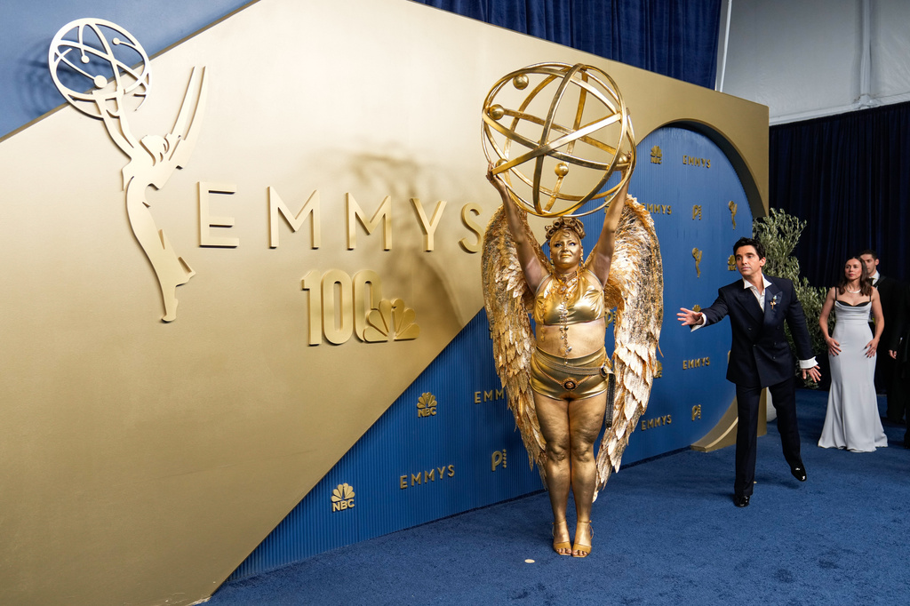 Meg Stalter, left, and Paul W. Downs arrive at the 78th Emmy Awards on Monday, Sept. 14, 2026, at the Peacock Theater in Los Angeles. (AP Photo/Mark J. Terrill)