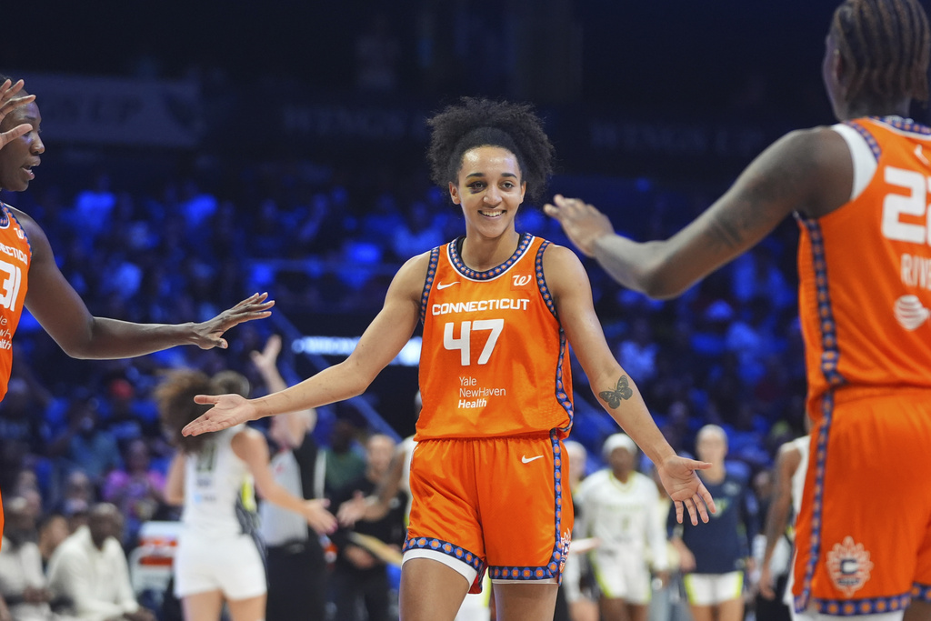 Connecticut Sun guard Leila Lacan (47) celebrates a play with teammates center Tina Charles (31) and guard Saniya Rivers during the second half of a WNBA basketball game against the Dallas Wings in Arlington, Texas, Wednesday, Aug. 27, 2025. (AP Photo/LM Otero)