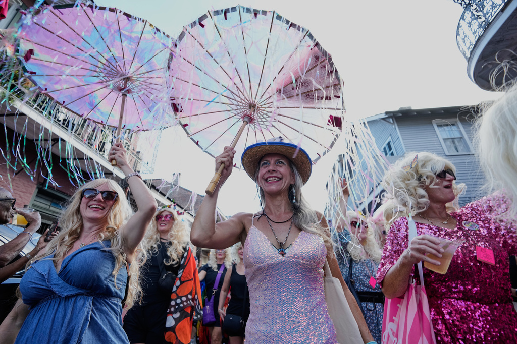 Members of the Krewe of Dolly lead a second line parade in commemoration of the life of Dolly Parton through the French Quarter Friday, Sept. 25, 2026, in New Orleans. (AP Photo/Gerald Herbert)