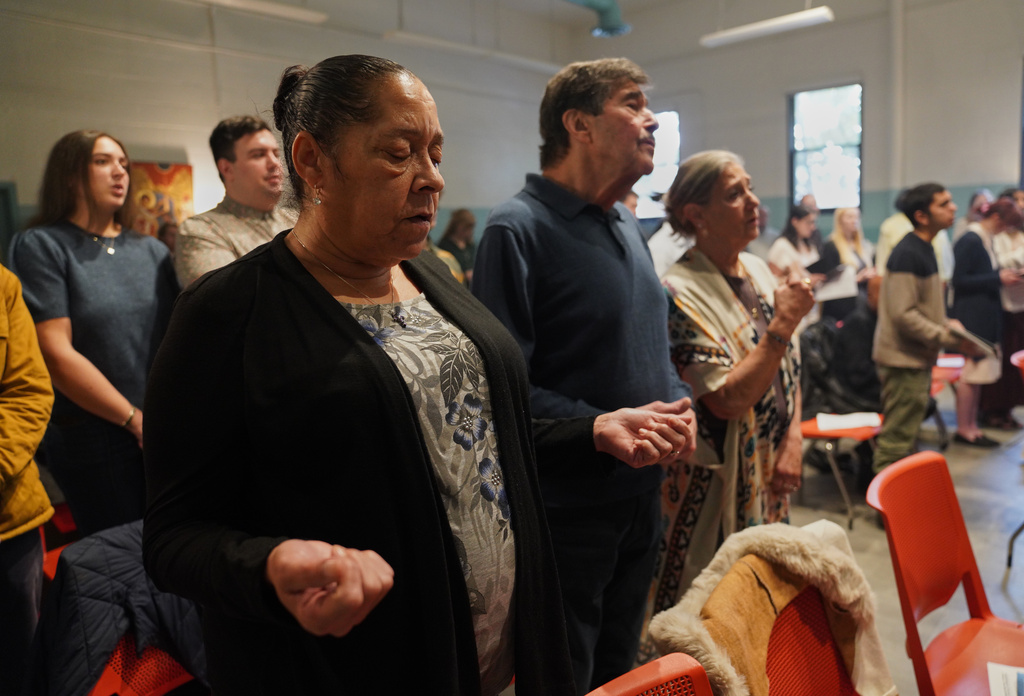 Members of St. Moses the Black Orthodox Church worship together during service on Sunday, Nov. 9, 2025, in Pittsburgh. (AP Photo/Jessie Wardarski)