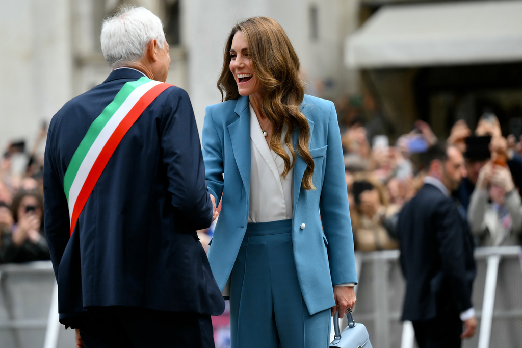 Britain's Kate, Princess of Wales, is welcomed by Mayor of Reggio Emilia Marco Massari as she arrives at the town hall, part of a two-day trip, in Reggio Emilia, Italy, Wednesday, May 13, 2026. (Marco Bertorello/Pool Photo via AP)