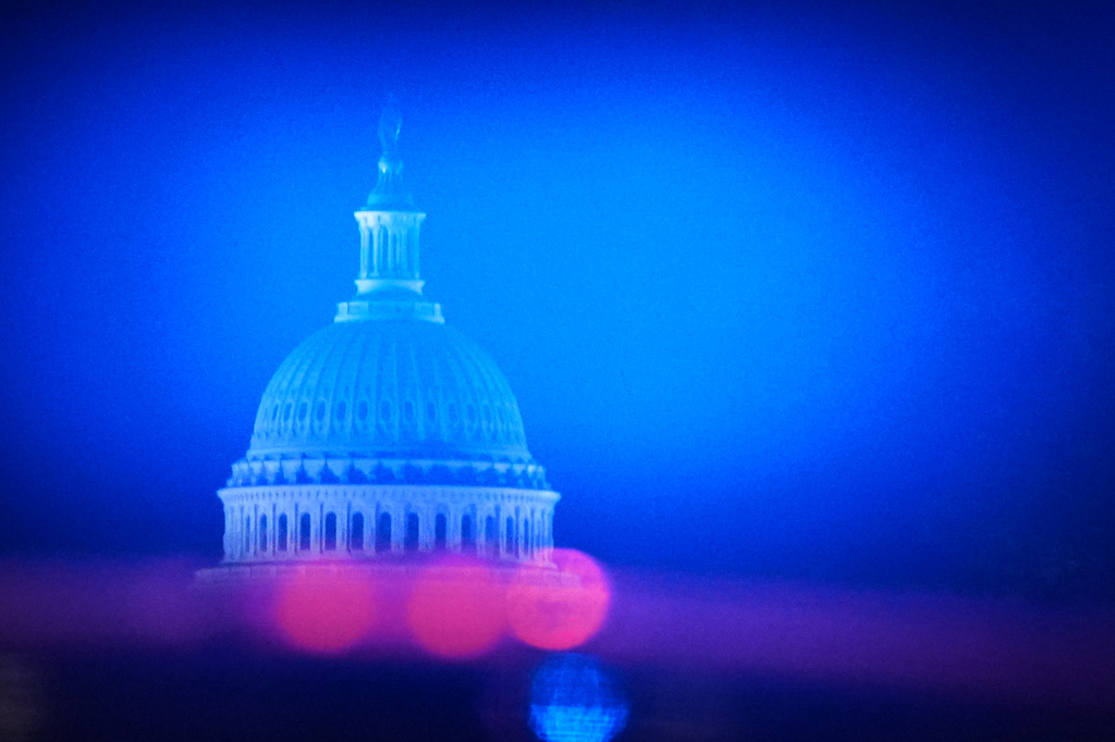 The U.S. Capitol is visible as the motorcade with President Donald Trump heads from the White House to Joint Base Andrews, Md., Monday, June 15, 2026. (AP Photo/Julia Demaree Nikhinson)