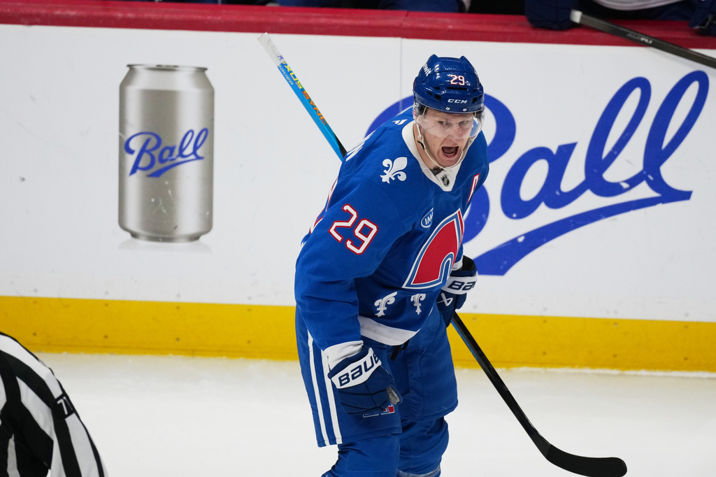 Colorado Avalanche center Nathan MacKinnon reacts after scoring his 50th goal of the season in the first period of an NHL hockey game against the Vancouver Canucks Wednesday, April 1, 2026, in Denver. (AP Photo/David Zalubowski)