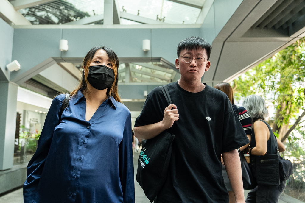 Former Scholarism member Tiffany Chin, left and Louis Lee, Joshua Wong's friend leave the High Court in Hong Kong, Wednesday, Sept. 2, 2026. (AP Photo/Chan Long Hei)