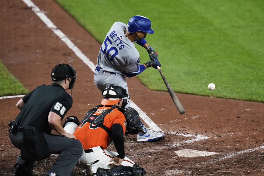 Los Angeles Dodgers' Mookie Betts (50) hits an RBI single during the fifth inning of a baseball game against the Baltimore Orioles, Saturday, Sept. 6, 2025, in Baltimore. (AP Photo/Stephanie Scarbrough)