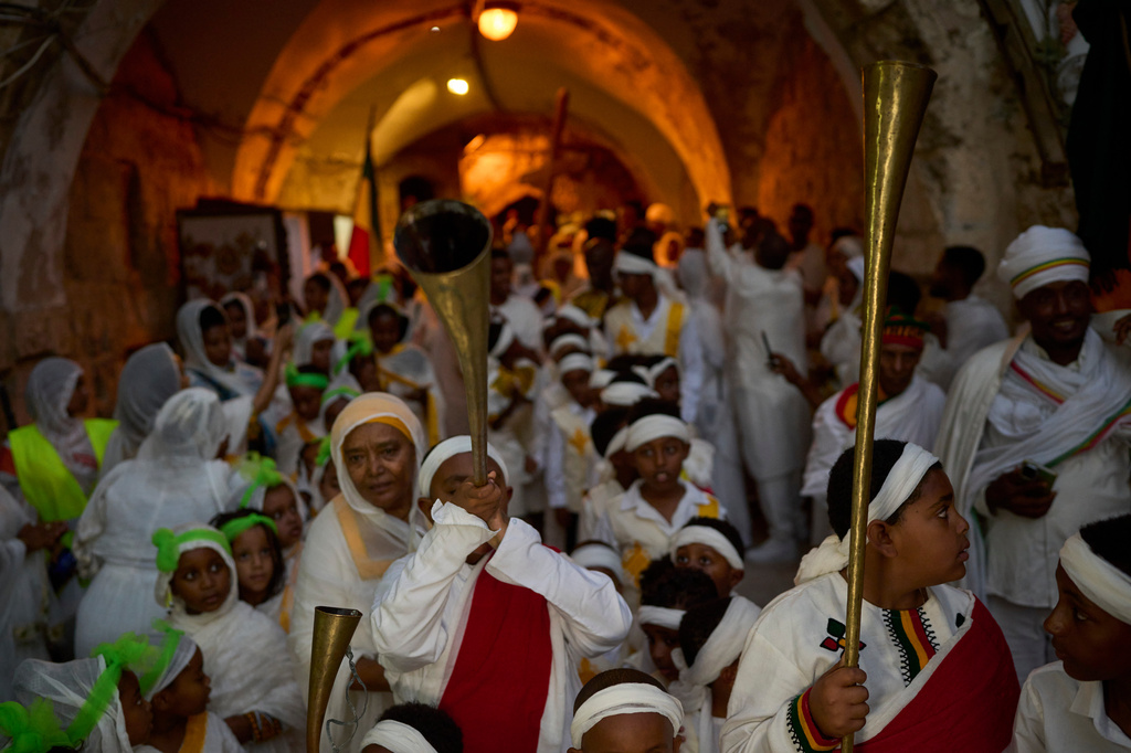 Ethiopian Orthodox Christian worshippers beat drums and sing to celebrate the eve of the Meskel holiday at the Ethiopian monks' village, Deir Al‑Sultan, located on the rooftop of the Church of the Holy Sepulcher in Jerusalem's Old City, Saturday, Sept. 26, 2026. (AP Photo/Ohad Zwigenberg)