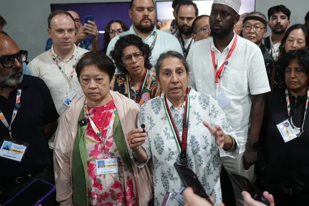 Tasneem Essop, center, from South Africa, executive director of the Climate Action, speaks next to Lidy Nacpil, Asian Peoples' Movement on Debt and Development, from the Philippines, center left, and others, during the COP30 U.N. Climate Summit, Friday, Nov. 21, 2025, in Belem, Brazil. (AP Photo/Andre Penner)