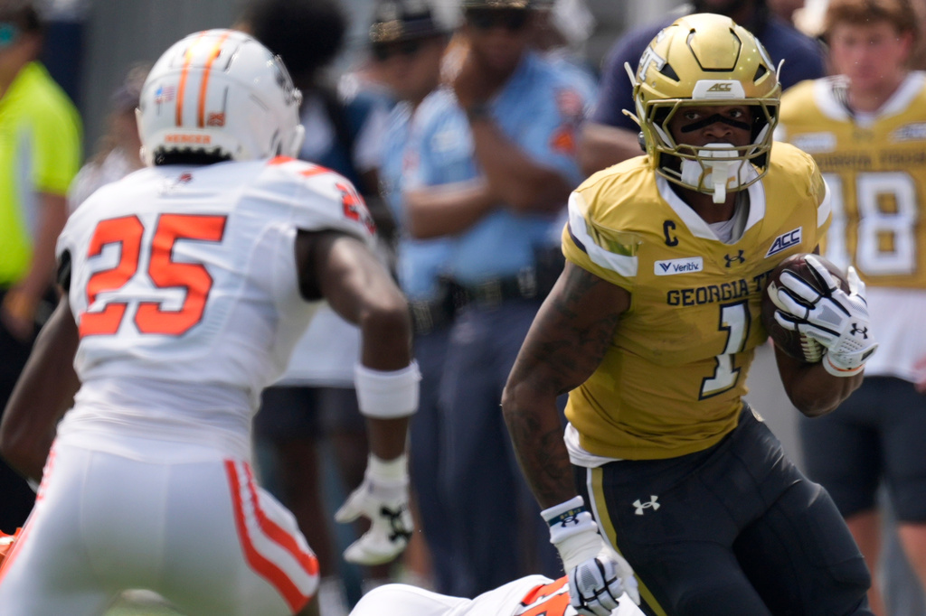 Georgia Tech running back Trelain Maddox (1) runs against Mercer linebacker Evin McDowell (25) in the first half of an NCAA college football game, Saturday, Sept. 19, 2026, in Atlanta. (AP Photo/Mike Stewart)