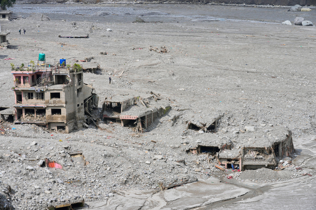 FILE - Houses damaged by recent flash floods stand amid thick layers of sludge, mud and debris in Nepal's Nuwakot district, Sept. 8, 2026. (AP Photo/Dar Yasin, File)