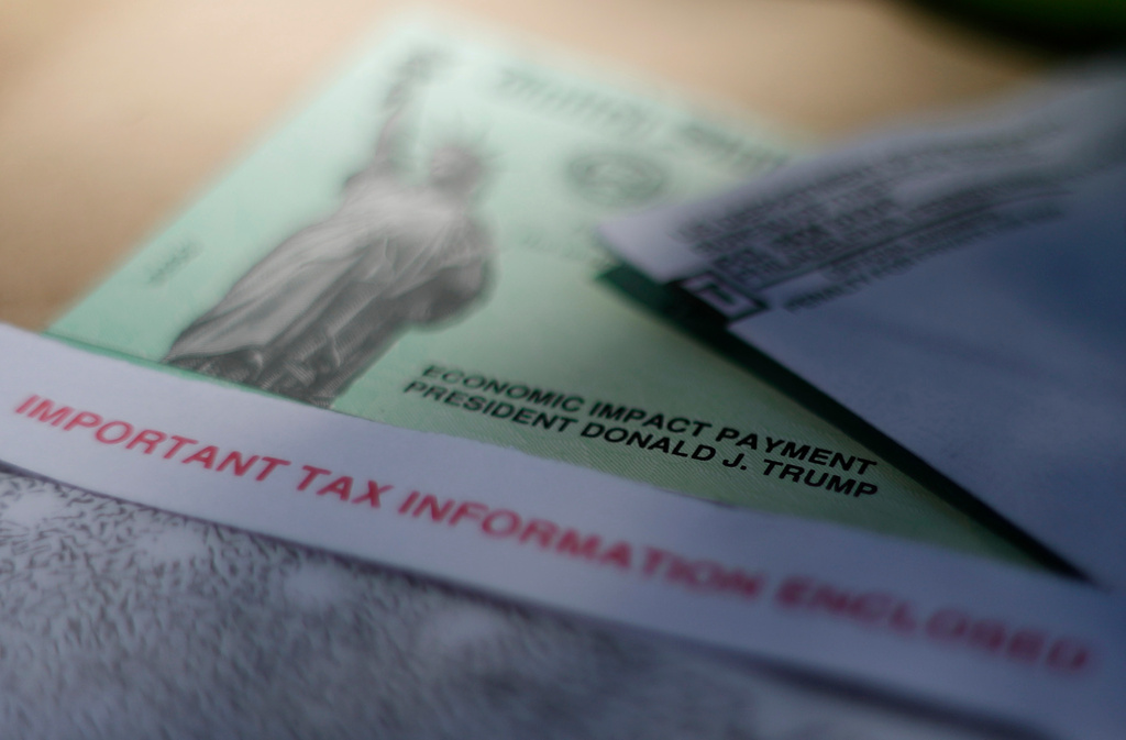 FILE - President Donald J. Trump's name is printed on a stimulus check issued by the IRS to help combat the adverse economic effects of the new coronavirus outbreak in San Antonio, April 23, 2020. (AP Photo/Eric Gay, File)