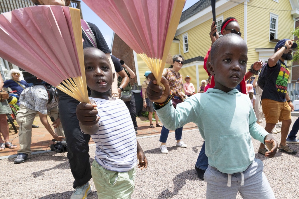 FILE - Levis Martin, left, and his brother Daniel dance with fans during a Juneteenth celebration in Portsmouth, N.H, on June 19, 2025. (AP Photo/Michael Dwyer, File)