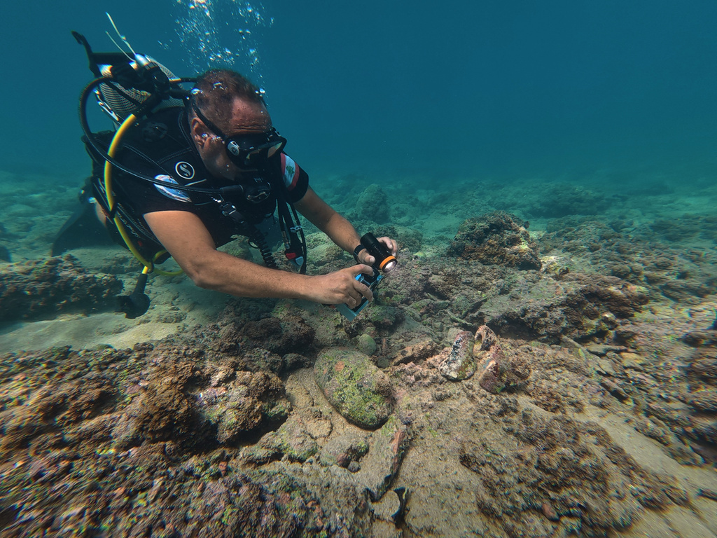 Manager of the Lebanon Diving Center, Youssef Jundi, takes video of pieces of ancient pottery at an archaeological site near the coast in the southern port city of Tyre, Lebanon, Thursday, Sept. 17, 2026. (AP Photo/Bilal Hussein)