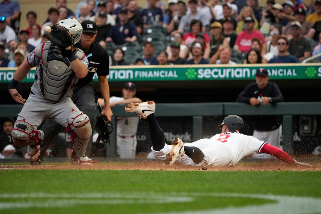 Minnesota Twins' Kody Clemens (2) scores on a sacrifice fly by Luke Keaschall during the fourth inning of a baseball game against the Cleveland Guardians, Wednesday, July 8, 2026, in Minneapolis. (AP Photo/Joseph Scheller)
