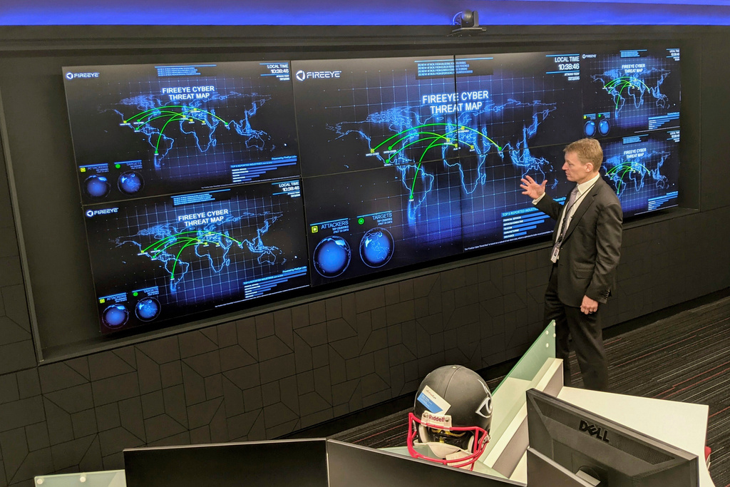 FILE - The CEO of FireEye Kevin Mandia gives a tour of the cybersecurity company's unused office space in Reston, Va., March 9, 2021. (AP Photo/Nathan Ellgren, file)