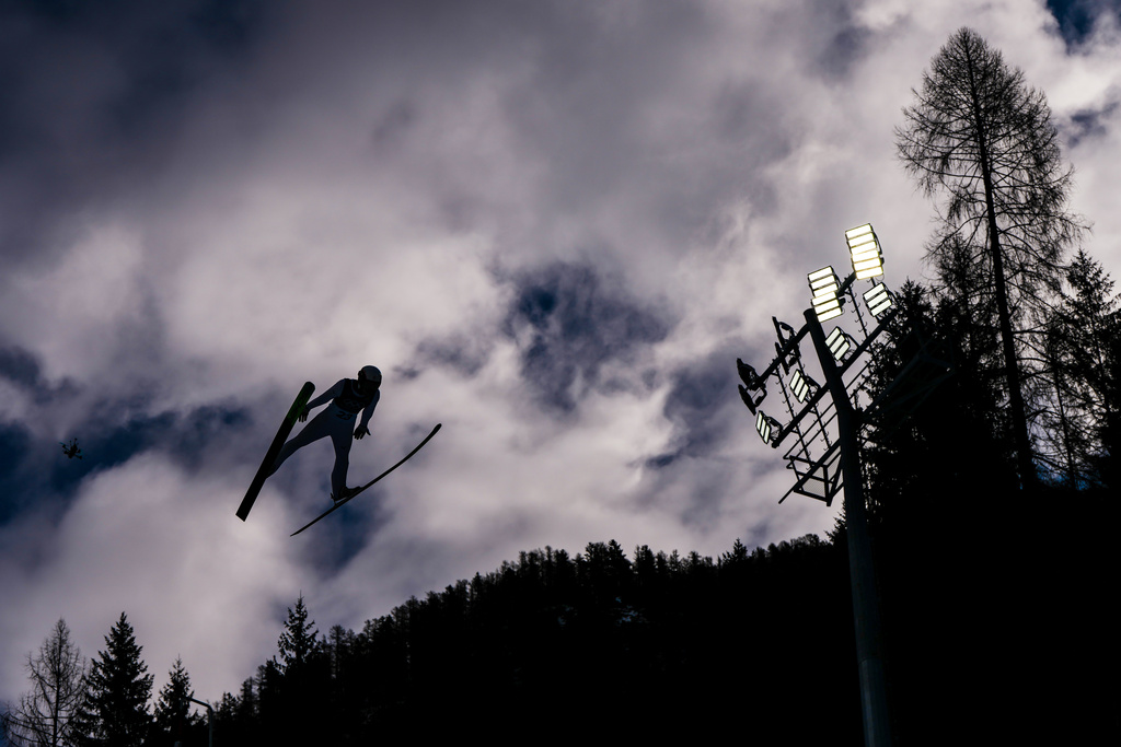 Ryota Yamamoto, of Japan, soars through the air during his competition round jump of the nordic combined individual Gundersen large hill/10km at the 2026 Winter Olympics, in Predazzo, Italy, Tuesday, Feb. 17, 2026. (AP Photo/Kirsty Wigglesworth)