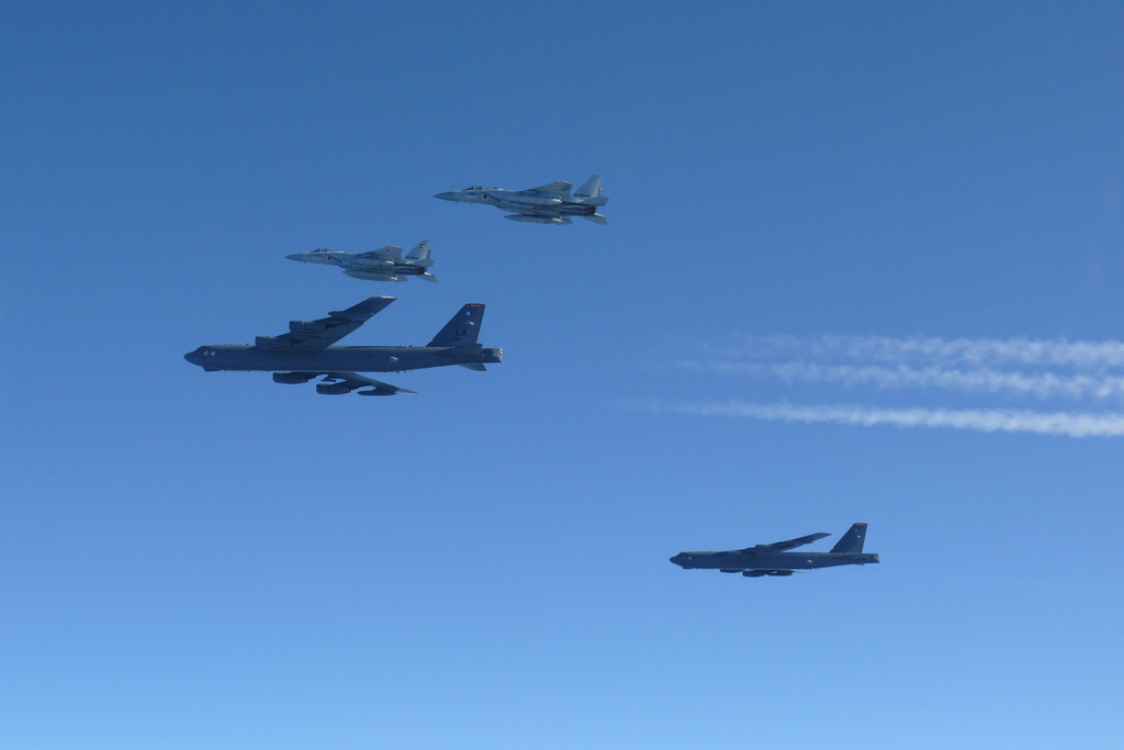 This photo provided by Japan's Ministry of Defense shows the Japan Air Self-Defense Force's F-15 fighters holding a joint military drill with the U.S. B-52 bombers in the vicinity of Japanese airspace on Wednesday Dec. 10, 2025. (Japan's Ministry of Defense via AP)