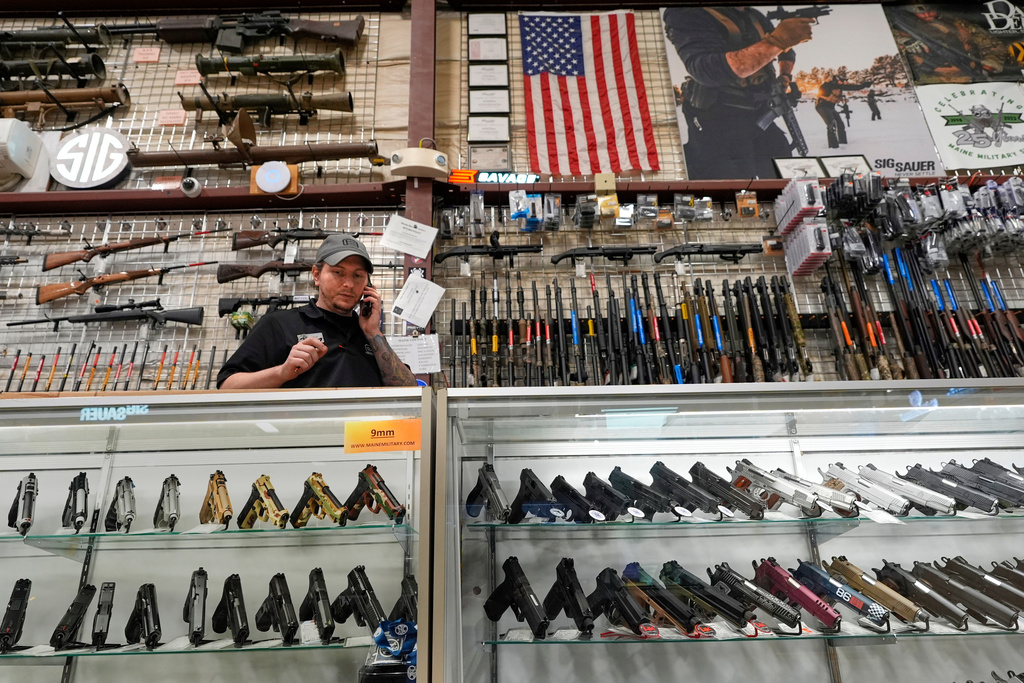 Nick Dustin, an employee at Maine Military Supply, calls a customer, Tuesday, Nov. 4, 2025, in Holden, Maine. (AP Photo/Robert F. Bukaty)