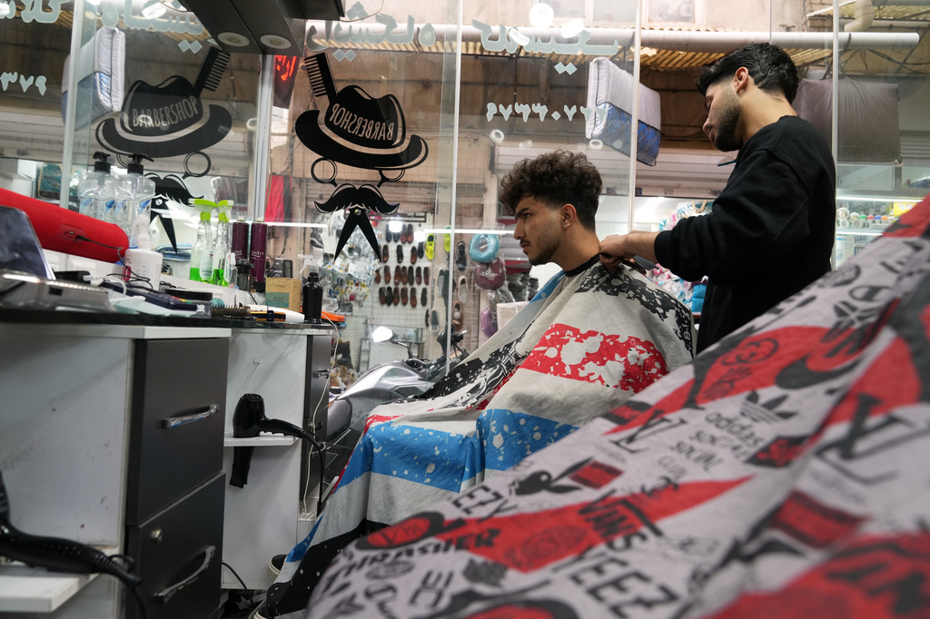 A young man gets a haircut at a barbershop near Tajrish Bazaar in Tehran, Iran, Tuesday, April 7, 2026. (AP Photo/Francisco Seco)