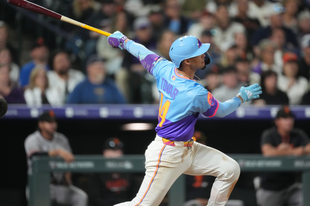 Colorado Rockies' Ezequiel Tovar follows the flight of his two-run home run off San Francisco Giants relief pitcher Caleb Kilian in the ninth inning of a baseball game Friday, May 29, 2026, in Denver. (AP Photo/David Zalubowski)