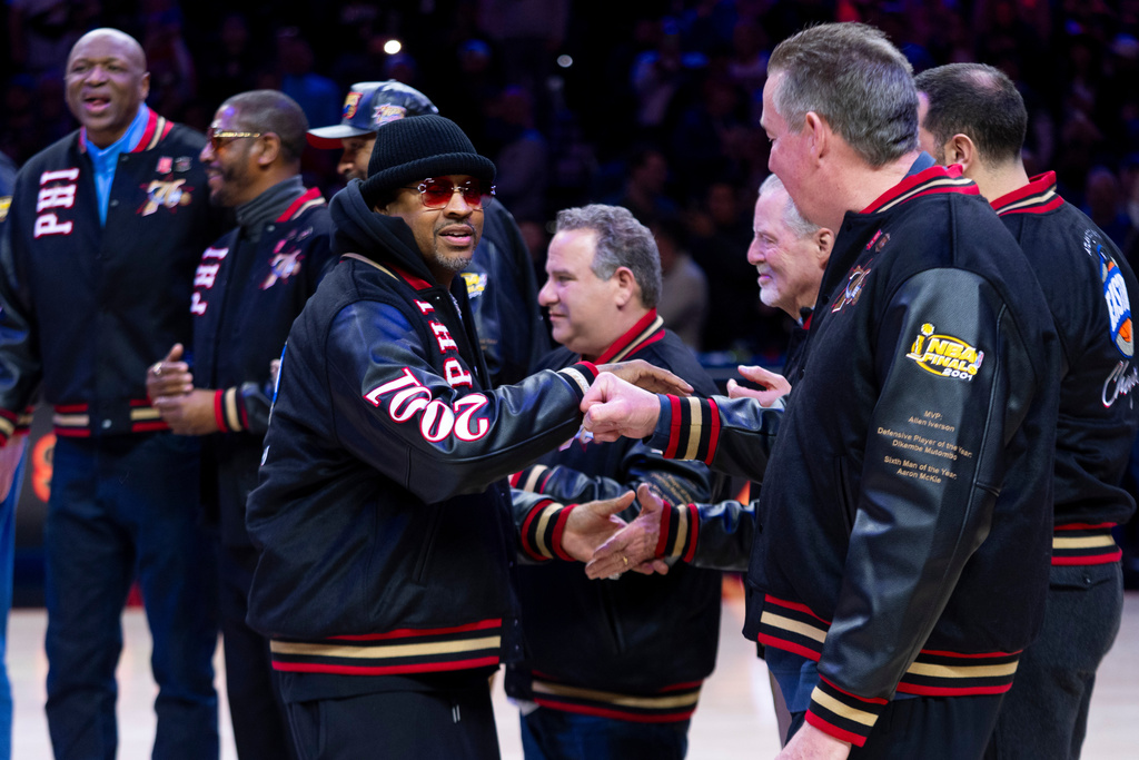 Allen Iverson is greeted by former teammates as Philadelphia 76ers honor the 2000-01 76ers team at halftime of an NBA basketball game against the New Orleans Pelicans, Saturday, Jan. 31, 2026, in Philadelphia. (AP Photo/Chris Szagola)
