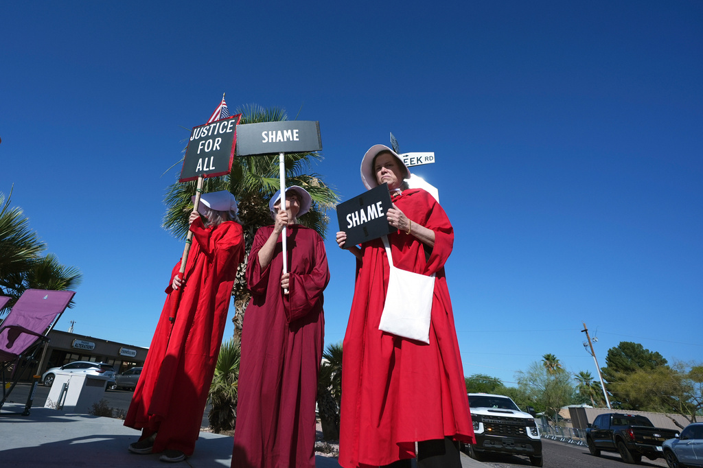 Protesters gather prior to a Turning Point USA event where President Donald Trump is scheduled to speak Friday, April 17, 2026, in Phoenix. (AP Photo/Ross D. Franklin)