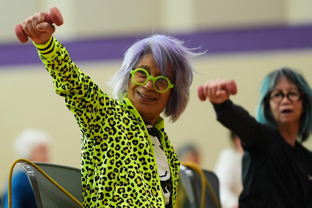Lili Bonilla raises light weights during an exercise class for older adults led by instructor Bengie Santos, 72, at the Dale Turner Family YMCA, April 30, 2026, in Shoreline, Wash. (AP Photo/Lindsey Wasson)