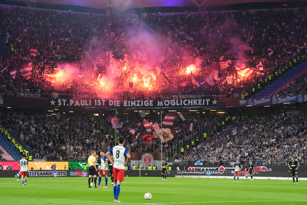 St. Pauli fans set off fireworks in the stands during the German Bundesliga soccer match between Hamburger SV and FC St. Pauli at Volksparkstadion in Hamburg, Germany, Friday, Aug. 29, 2025. (Christian Charisius/dpa via AP)