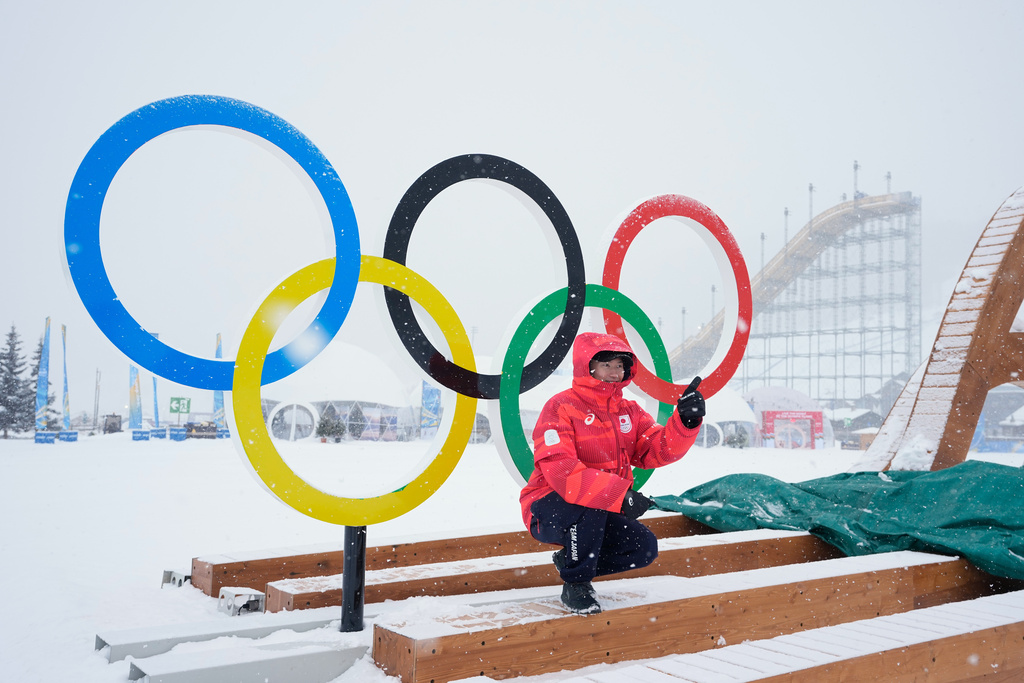 Japan's Goshin Fujiki poses for a photo in front of the Olympic rings at the 2026 Winter Olympics, in Livigno, Italy, Wednesday, Feb. 4, 2026. (AP Photo/Gregory Bull)