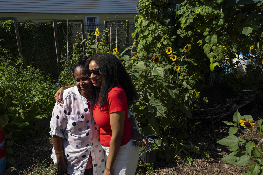 Alicia White, president and founder of the Project Petals, right, and Harini Bangera, a volunteer, embrace at Paradise Community Garden, Friday, Aug. 8, 2025, in Inwood, N.Y. (AP Photo/Yuki Iwamura)