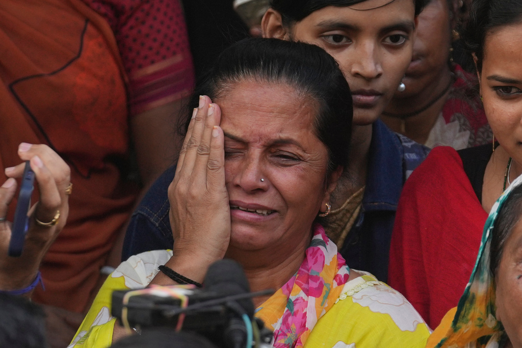 A fan mourns outside a cremation center to pay homage to Bollywood actor Dharmendra who died Monday, in Mumbai India, Monday, Nov. 24, 2025.(AP Photo/Rafiq Maqbool)