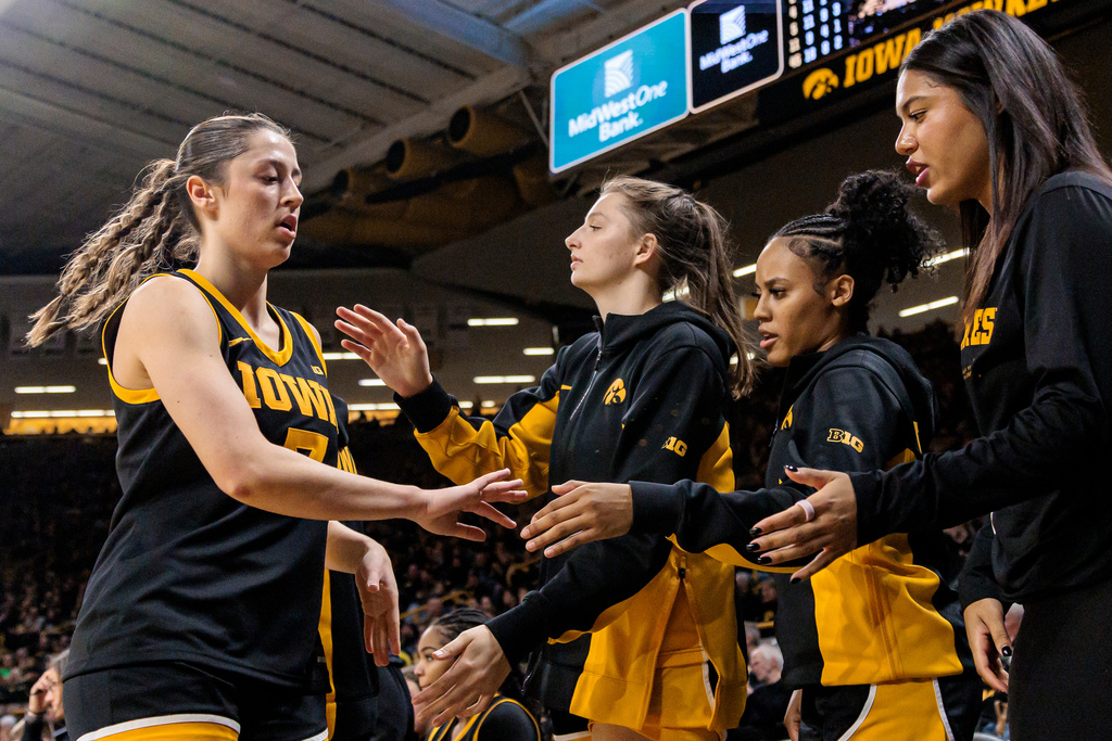 Iowa guard Addison Deal, left, high fives teammates during a Big Ten conference NCAA college basketball game against Oregon in Iowa City, Iowa, Thursday, Jan. 15, 2026. (Nick Rohlman/The Gazette via AP)