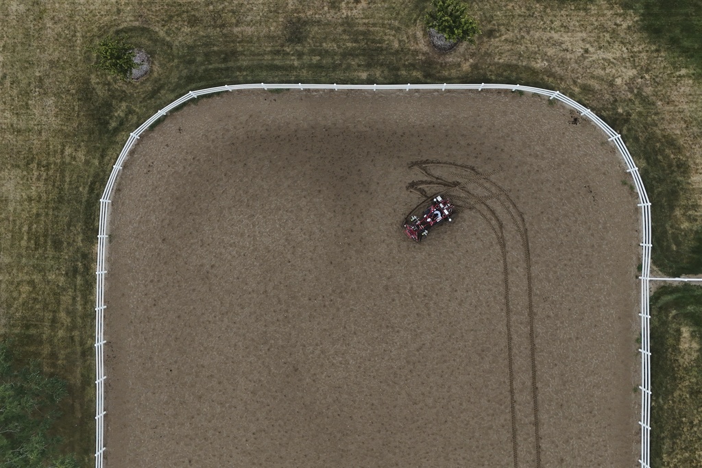 MK Bashar drives an electric tractor Tuesday, Aug. 19, 2025, during a demonstration in East Lansing, Mich. (AP Photo/Joshua A. Bickel)