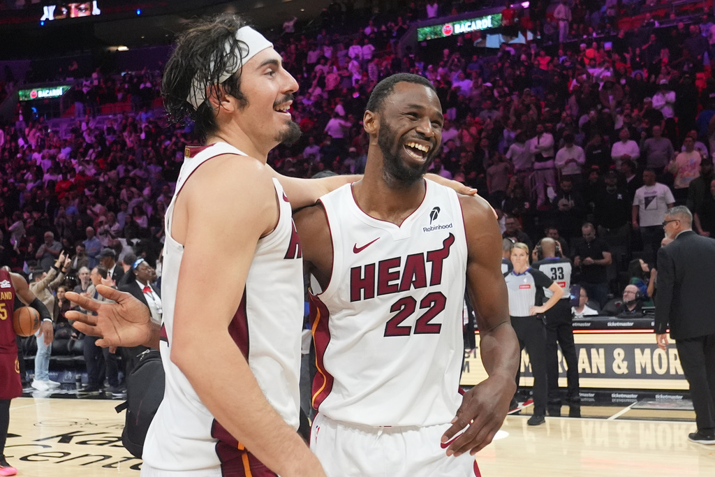 Miami Heat forward Andrew Wiggins (22) celebrates with forward Jaime Jaquez Jr. after scoring the winning basket in overtime during an NBA basketball game against the Cleveland Cavaliers Monday, Nov. 10, 2025, in Miami. (AP Photo/Marta Lavandier)