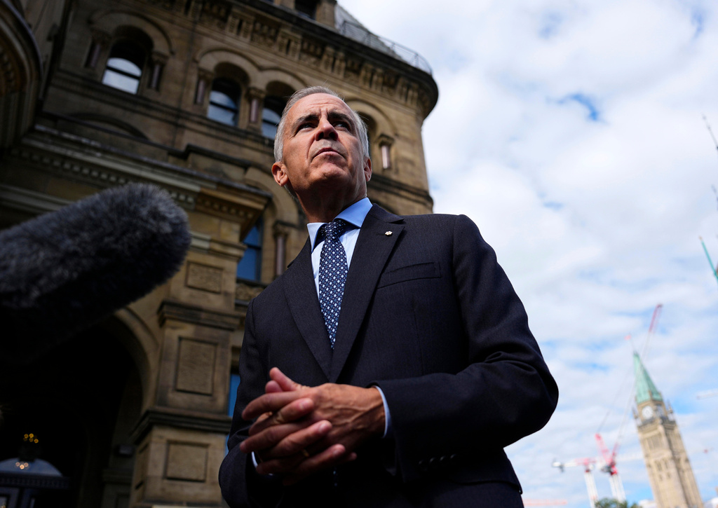 Canadian Prime Minister Mark Carney speaks with members of the media as he arrives at the Office of the Prime Minister and Privy Council in Ottawa, on Tuesday, Sept. 1, 2026. (Justin Tang/The Canadian Press via AP)